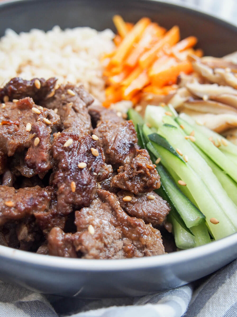 side close up view of beef bulgogi bowl served with rice and easy Korean-style vegetables