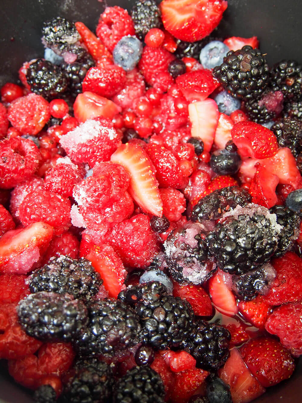 berries in pan with sugar before cooking slightly