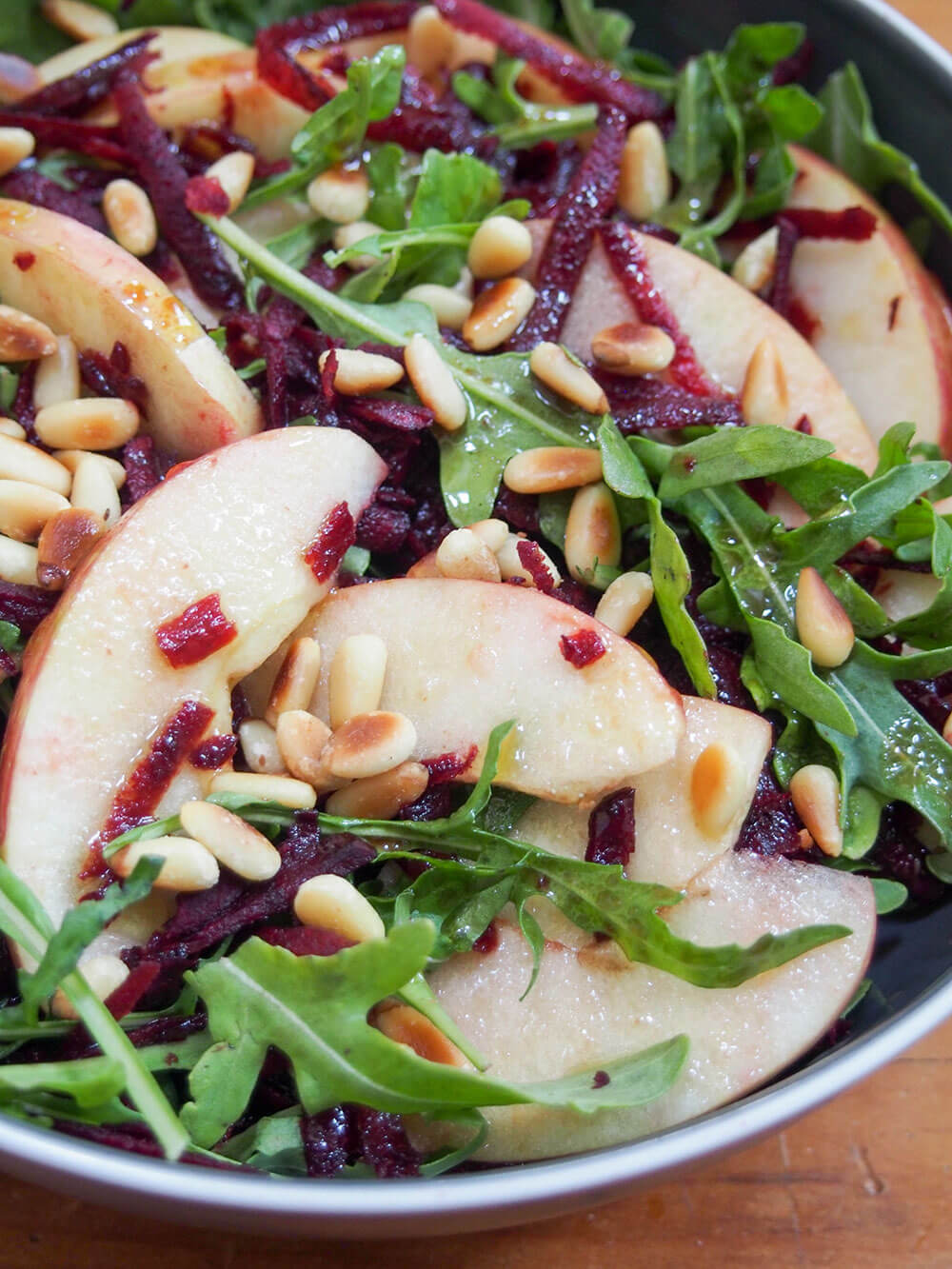 This beet apple salad with maple vinaigrette is incredibly easy to make and packed with autumnal flavor. Crunchy, flavorful and great as an appetizer or side. beet apple salad with maple vinaigrette close up