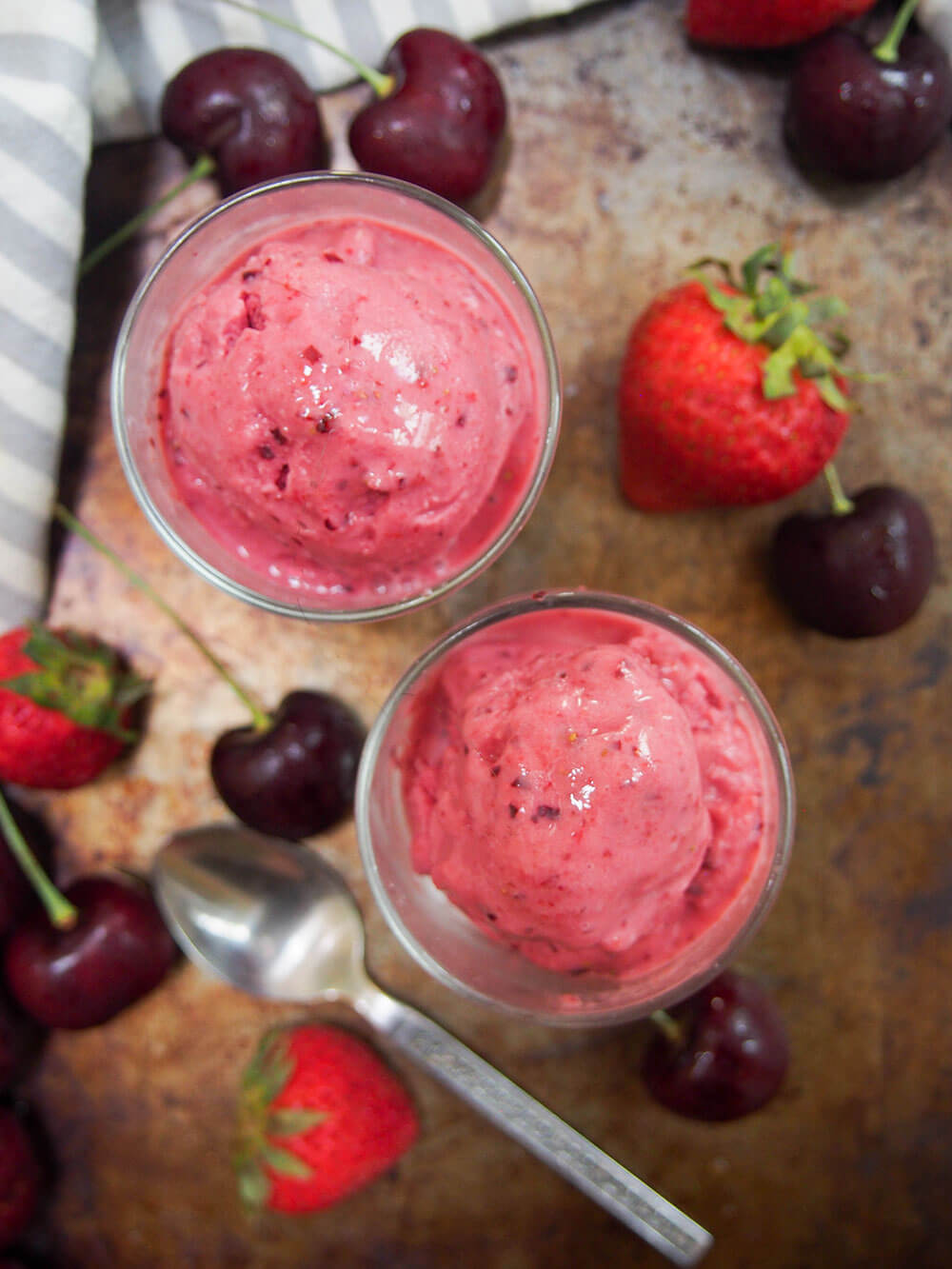 two glasses of cherry strawberry frozen yogurt from above