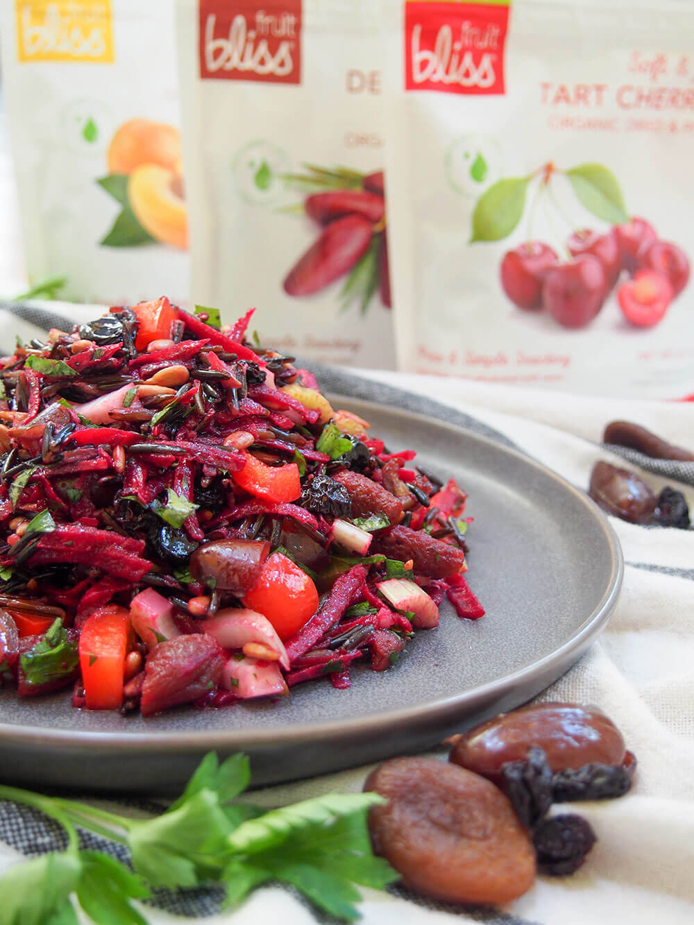 This wild rice salad is a wonderful combination of textures and flavors. A little tart from the vinaigrette, sweet from the dried fruit, with crunchy veg and tender fruit. And a whole lot of wholesome tastiness. wild rice salad with Fruit Bliss packets behind