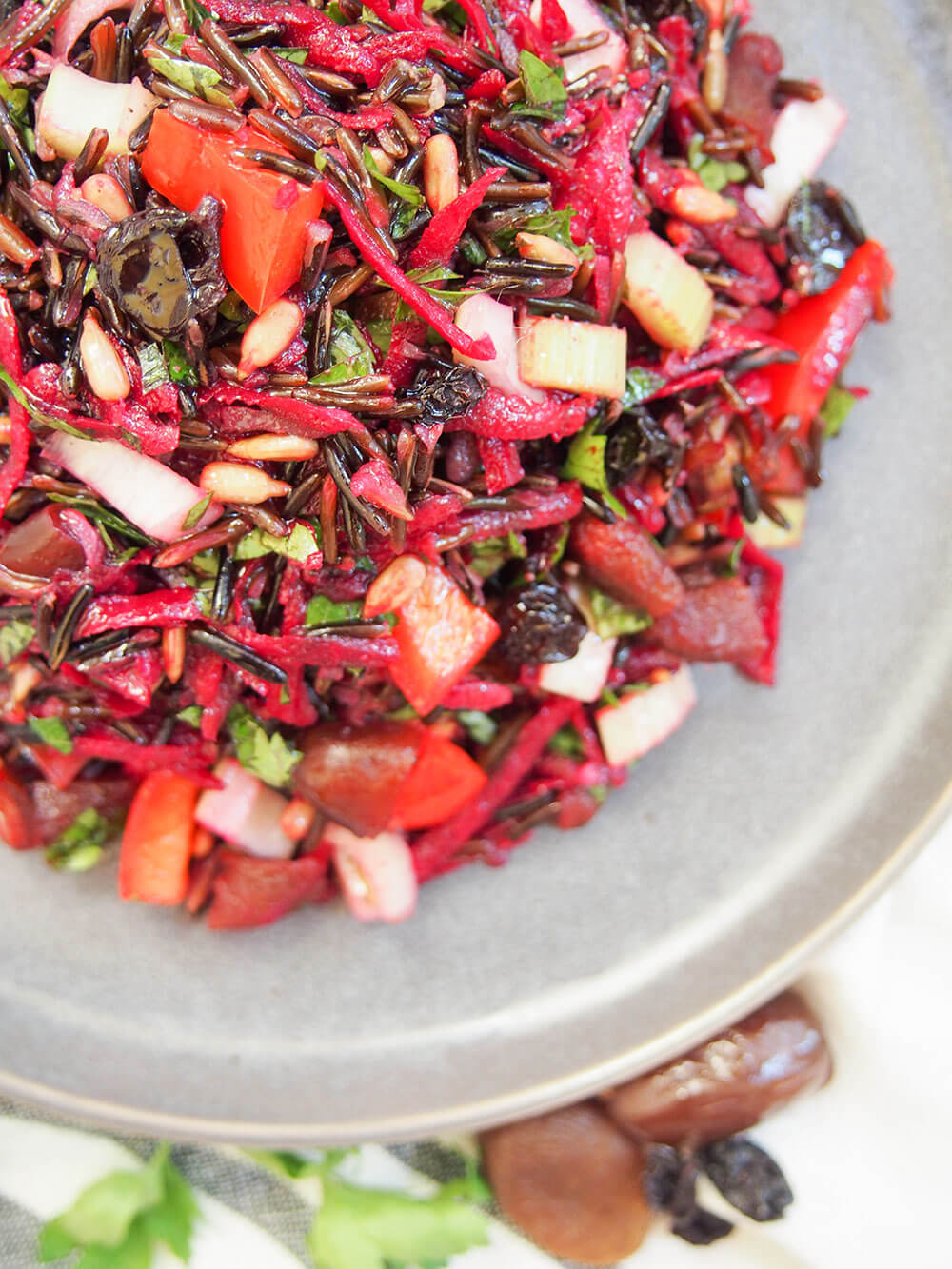 This wild rice salad is a wonderful combination of textures and flavors. A little tart from the vinaigrette, sweet from the dried fruit, with crunchy veg and tender fruit. And a whole lot of wholesome tastiness. wild rice salad overhead shot