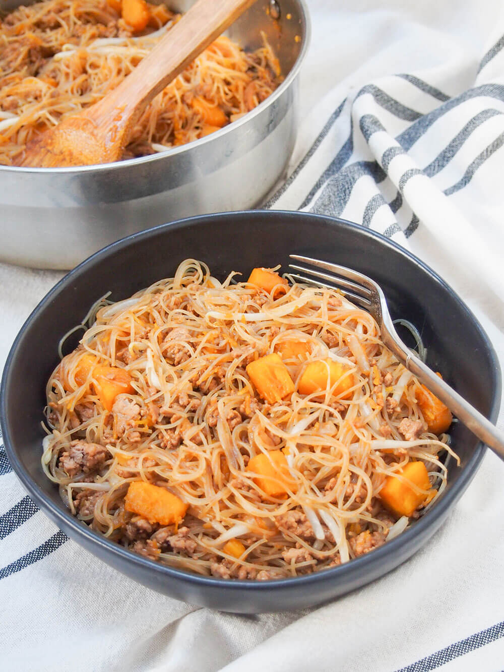 Taiwanese pumpkin rice noodles part in bowl and part in pan