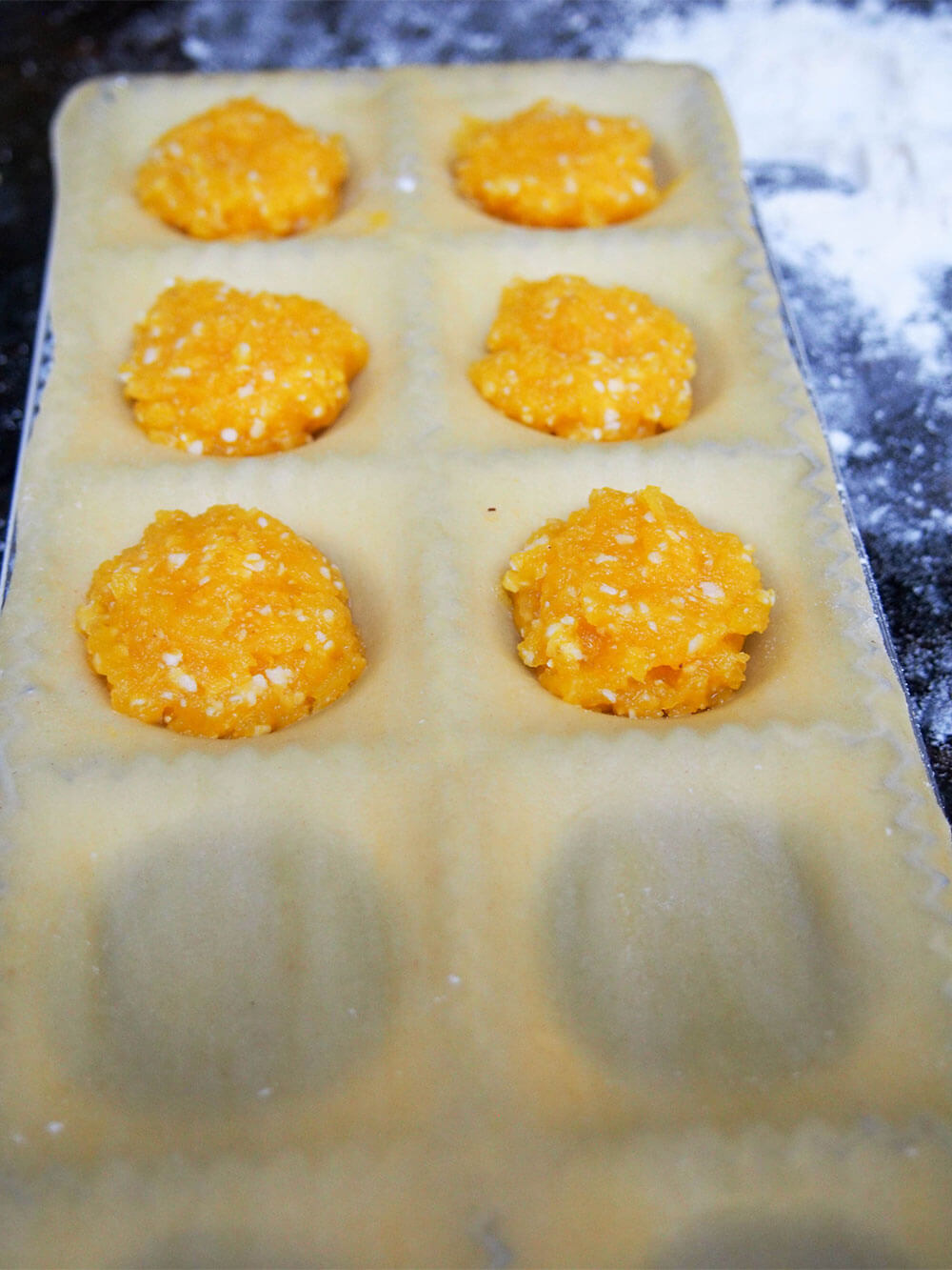 adding filling to pumpkin ravioli