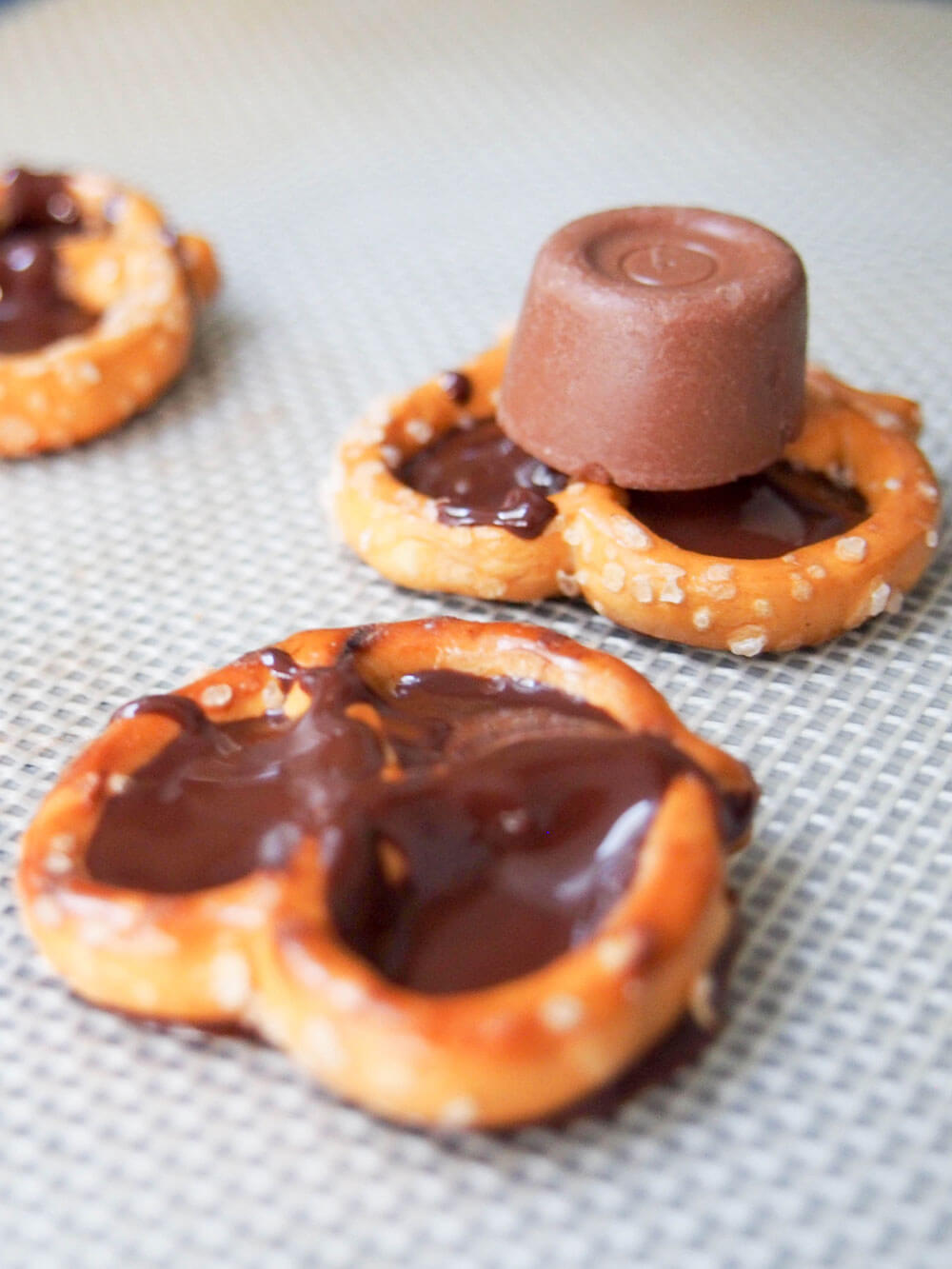 filling base pretzel with chocolate then topping with chocolate rolo