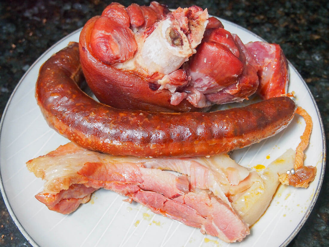 meat taken out of bean pot to chop up and add back in