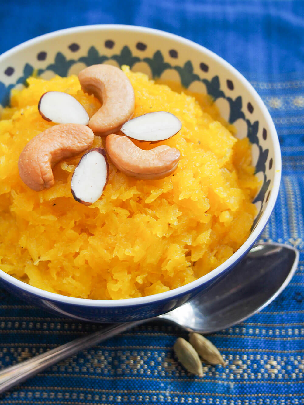 pumpkin halwa decorated with nuts and spoon under bowl