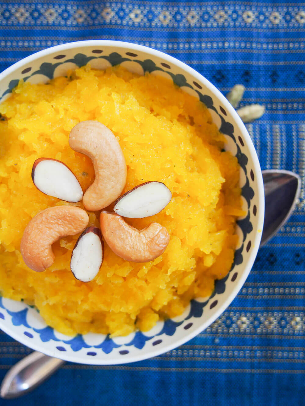 close up of bowl of pumpkin halwa decorated with nuts