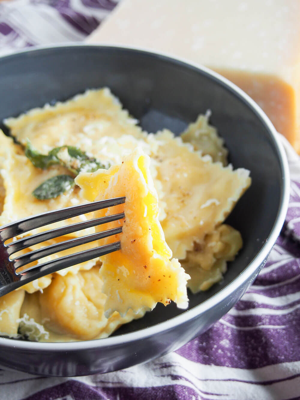pumpkin ravioli with one on fork bitten into