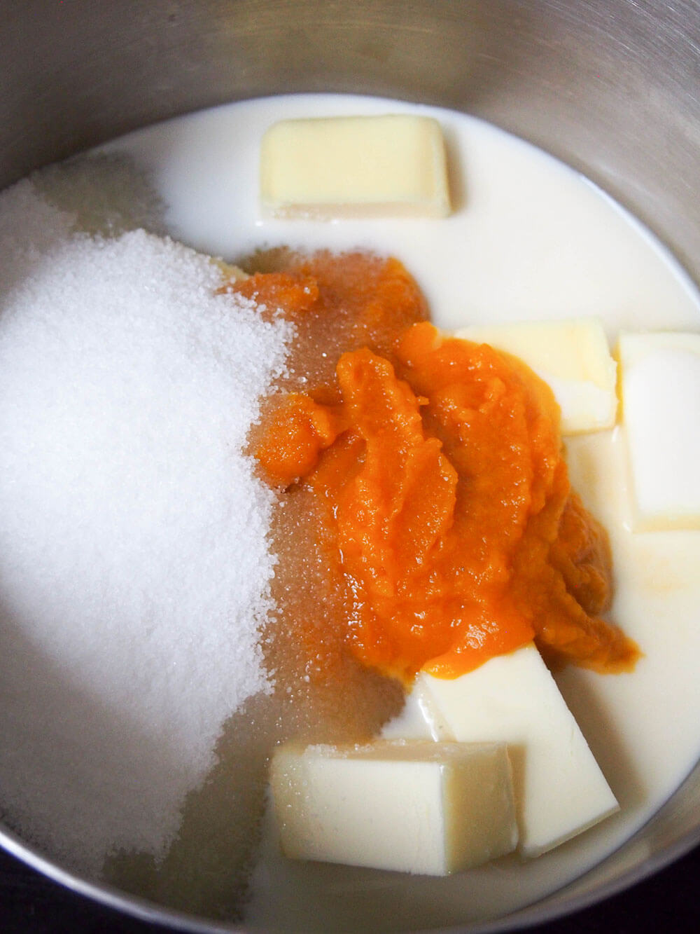 first step in making no bake pumpkin cookies - sugar, butter, pumpkin and milk in pan