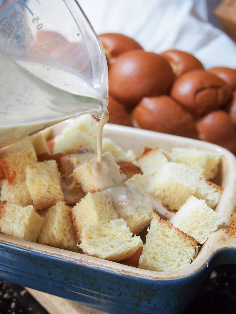 adding custard to strawberry French toast bake 