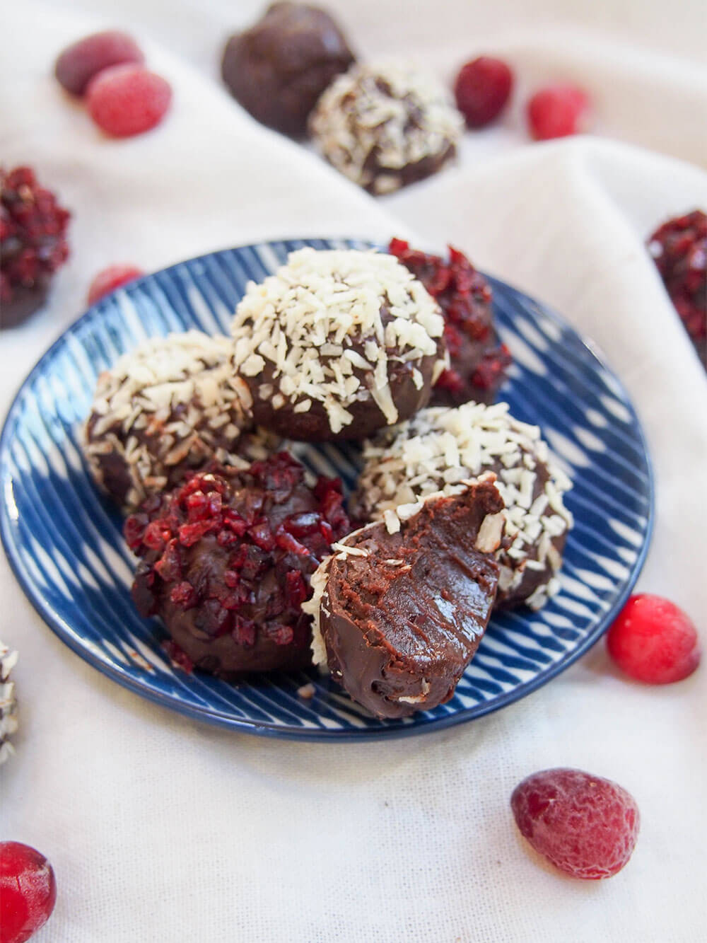 cranberry truffles on plate with one with a bite taken out