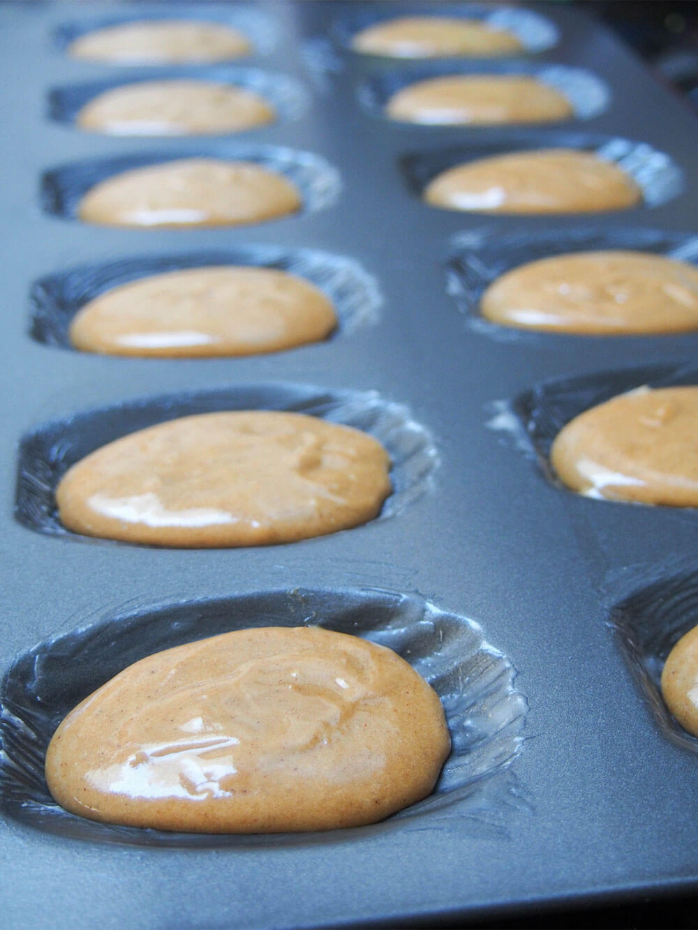 gingerbread madeleines mixture in pan ready to bake
