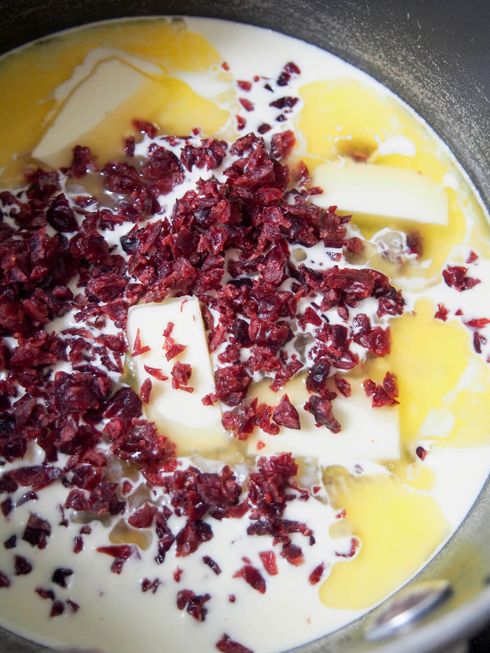 melting cream and butter with chopped dried cranberries added