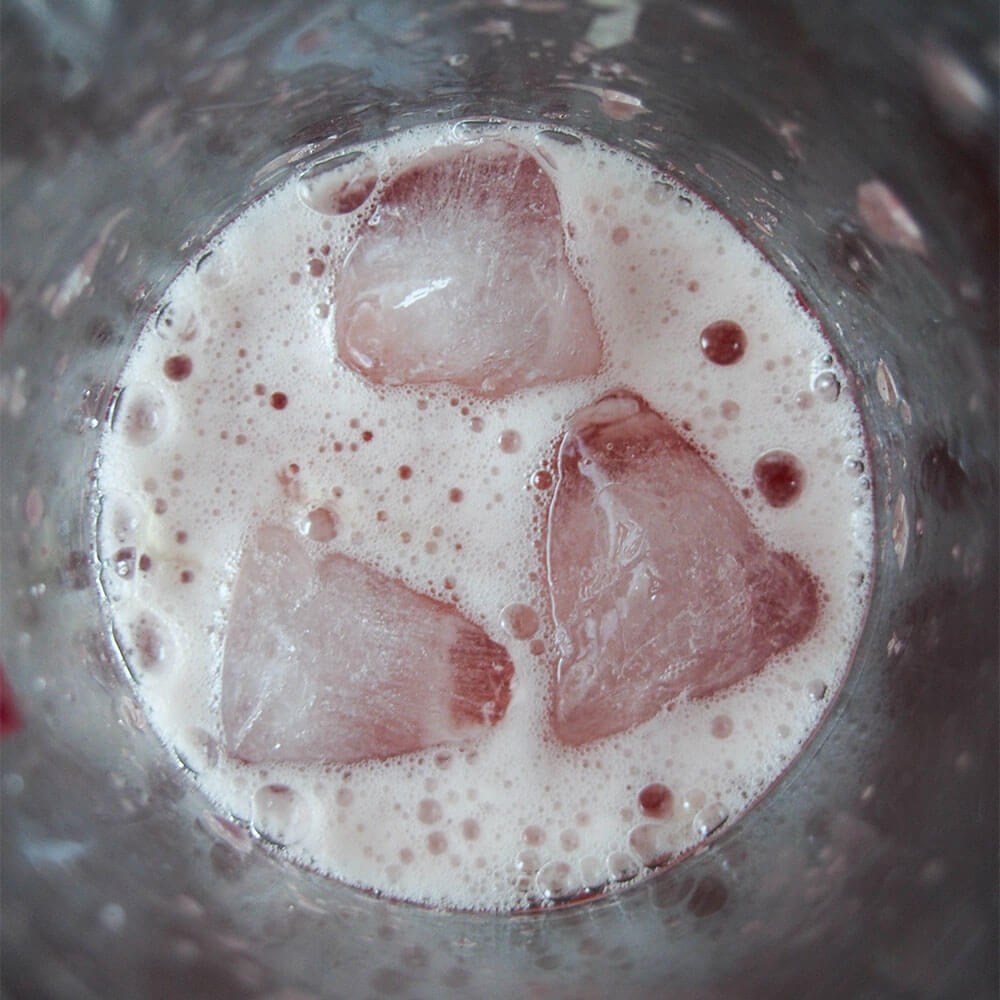 shaken cocktail showing froth and ice