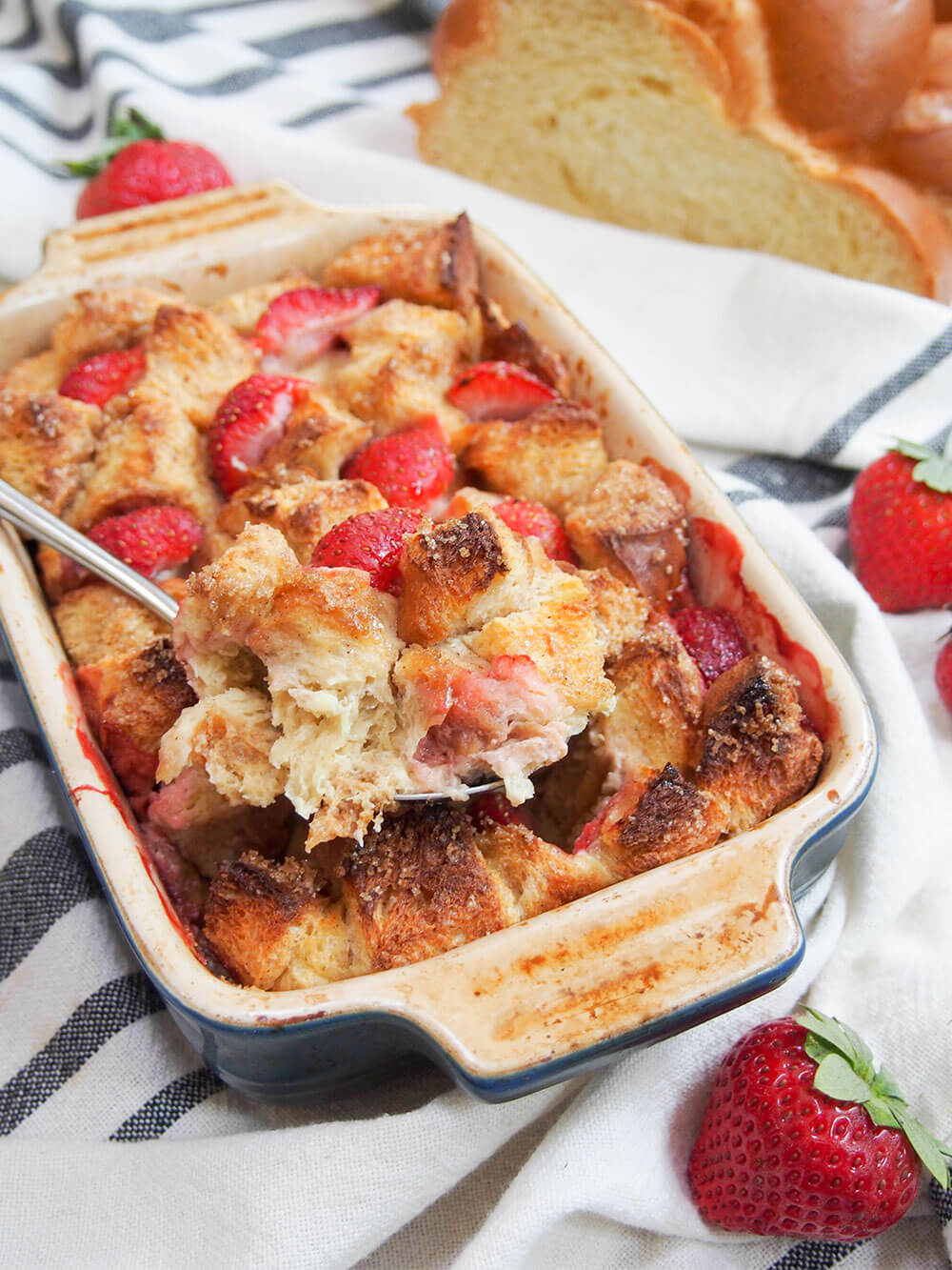 strawberry French toast bake with spoonful resting on top of rest in dish