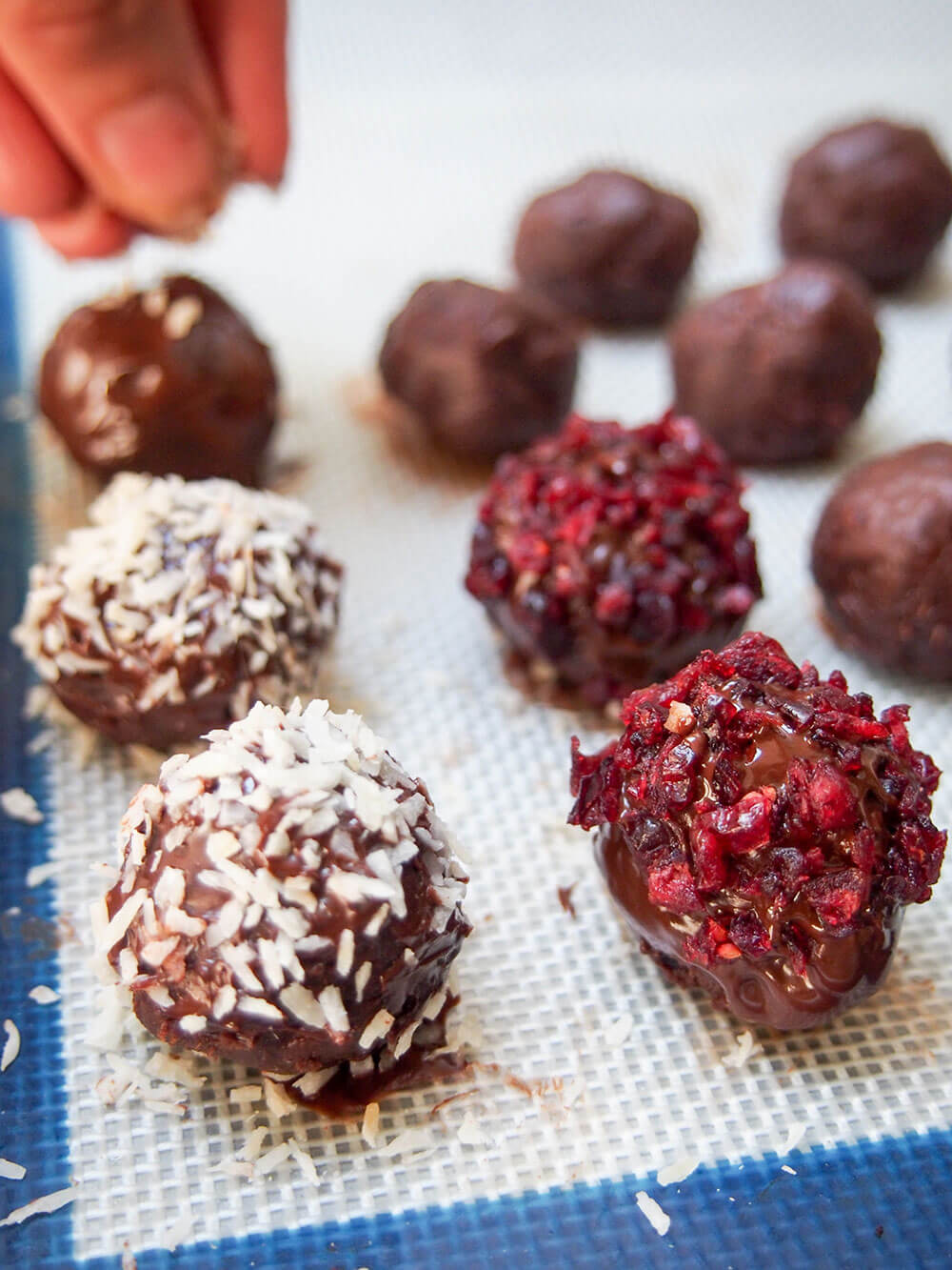 sprinkling topping on cranberry truffles