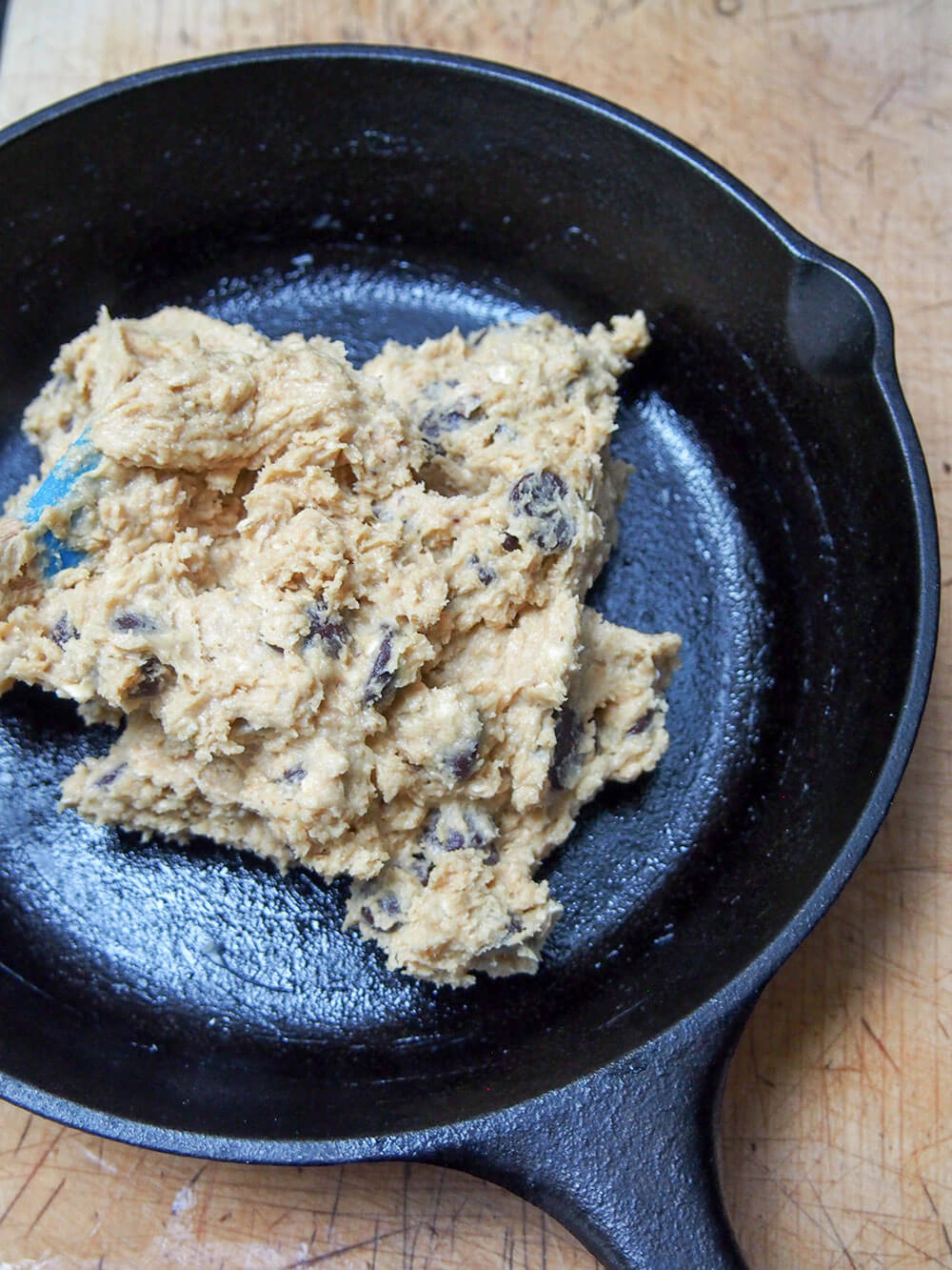 Oatmeal chocolate chip skillet cookie dough in pan