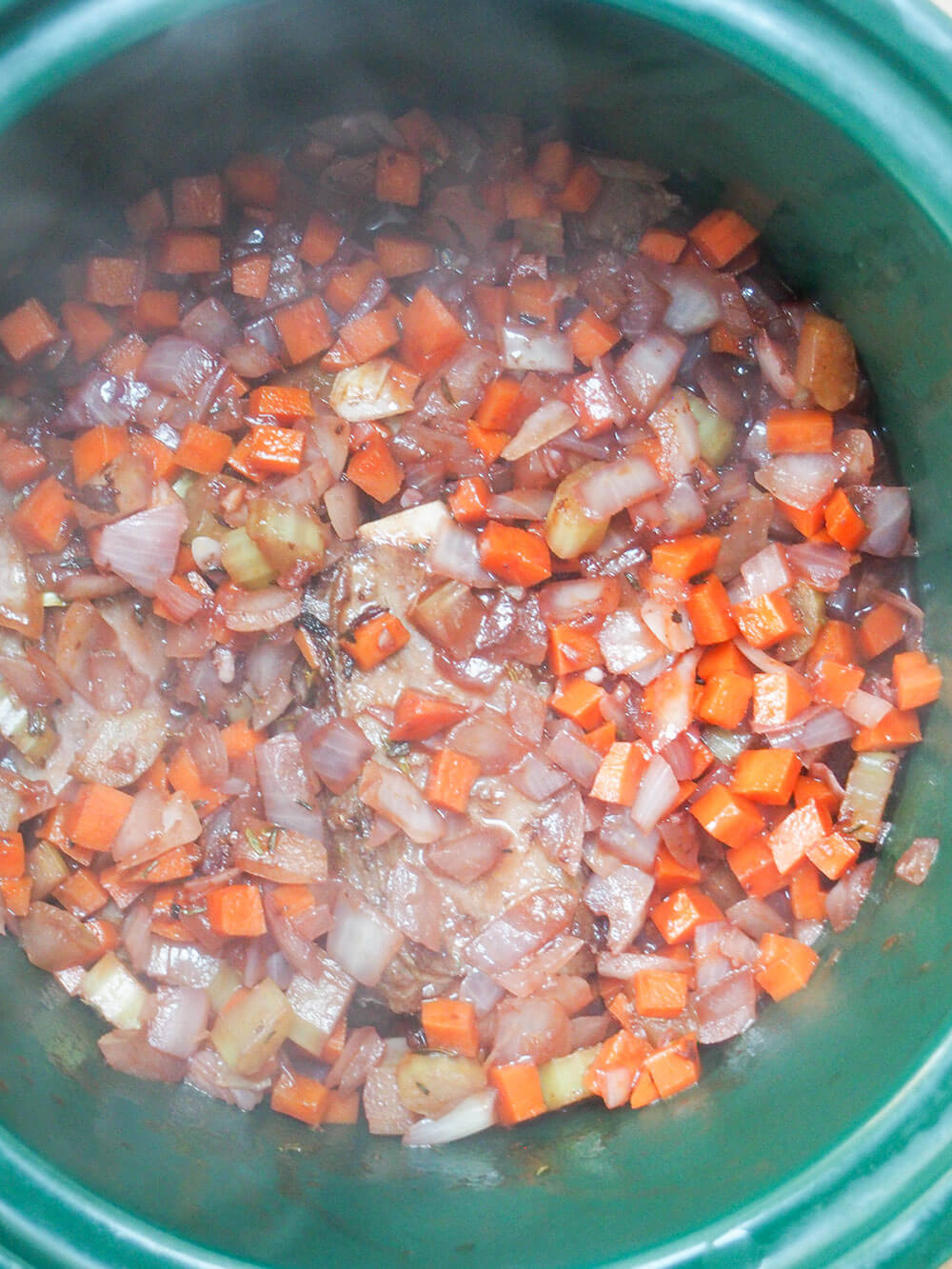 adding ribs to slow cooker and sauce over top for slow cooker short ribs adding ribs to slow cooker with sauce over top