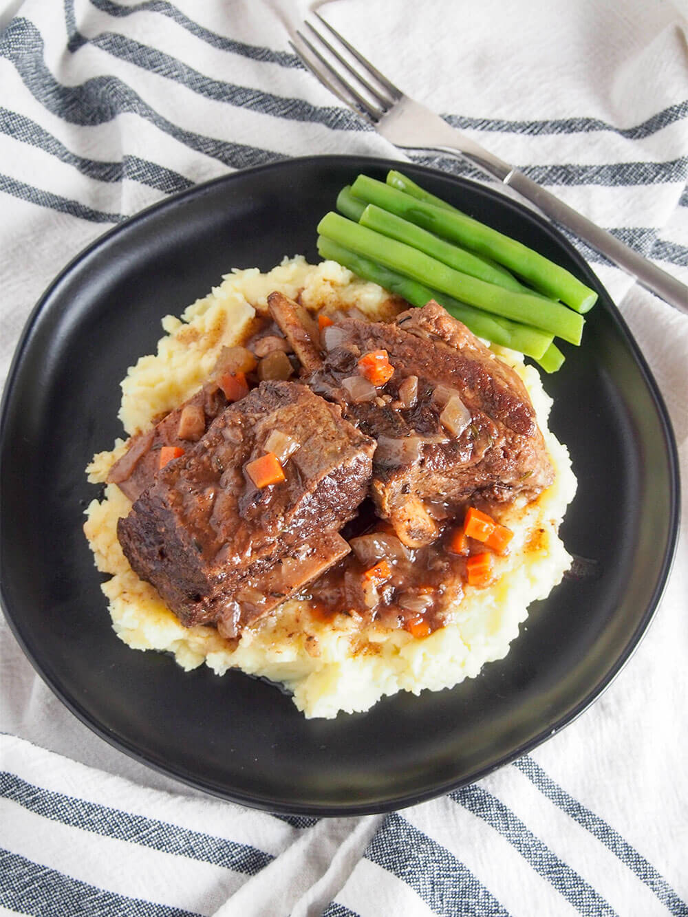 These slow cooker short ribs are easy to prepare, fall-off-the-bone tender and packed with flavor after testing for the perfect set of ingredients. So good. slow cooker short ribs overhead shot
