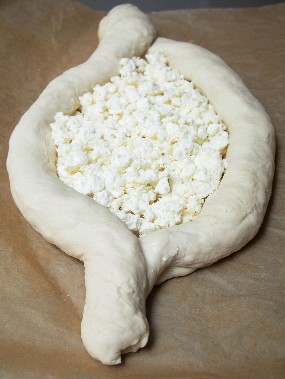 cheese added to middle of shaped dough, ready to bake