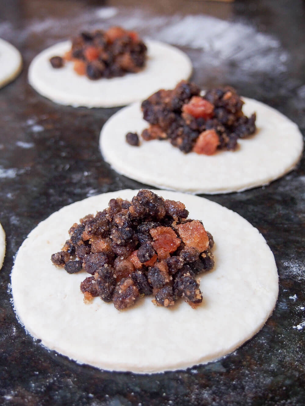 adding filling to Eccles cakes adding filling to Eccles cakes