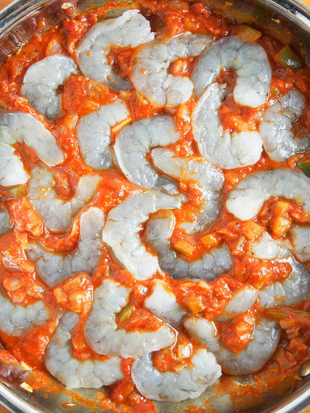 adding shrimp to shrimp Creole sauce