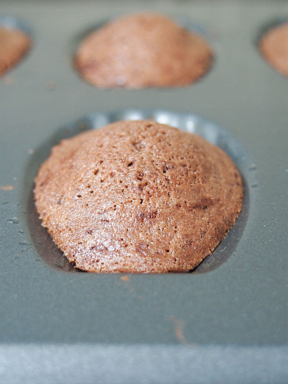 chocolate madeleines straight out the oven with clear 'hump'