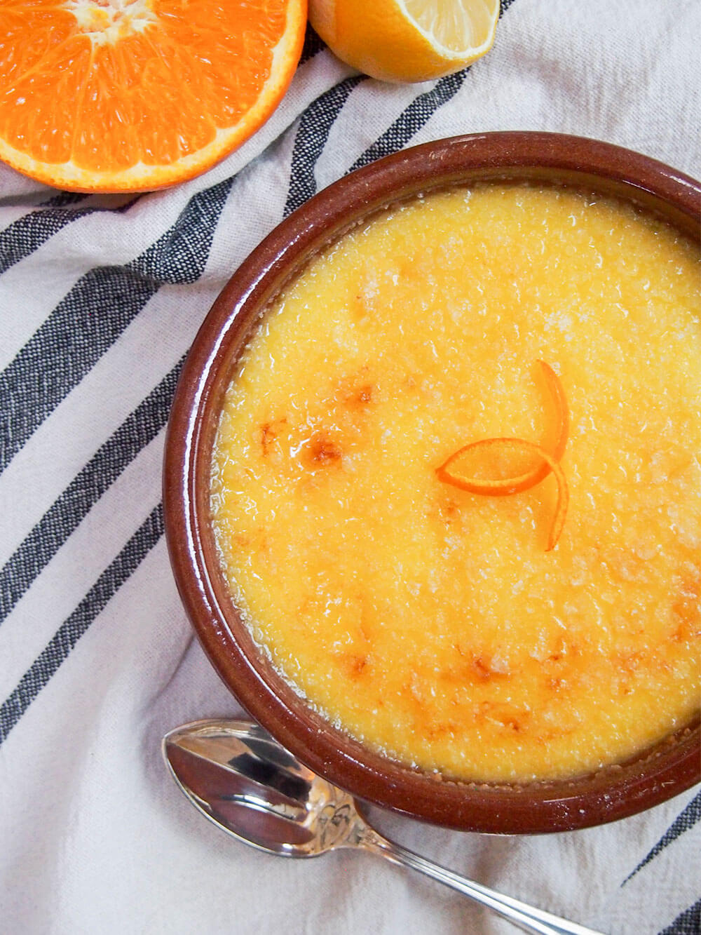 crema Catalana with spoon to side and orange and lemon in corner