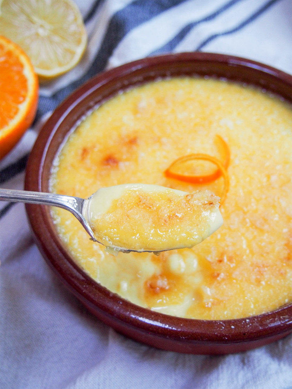 crema Catalana with spoonful taken out and held in front