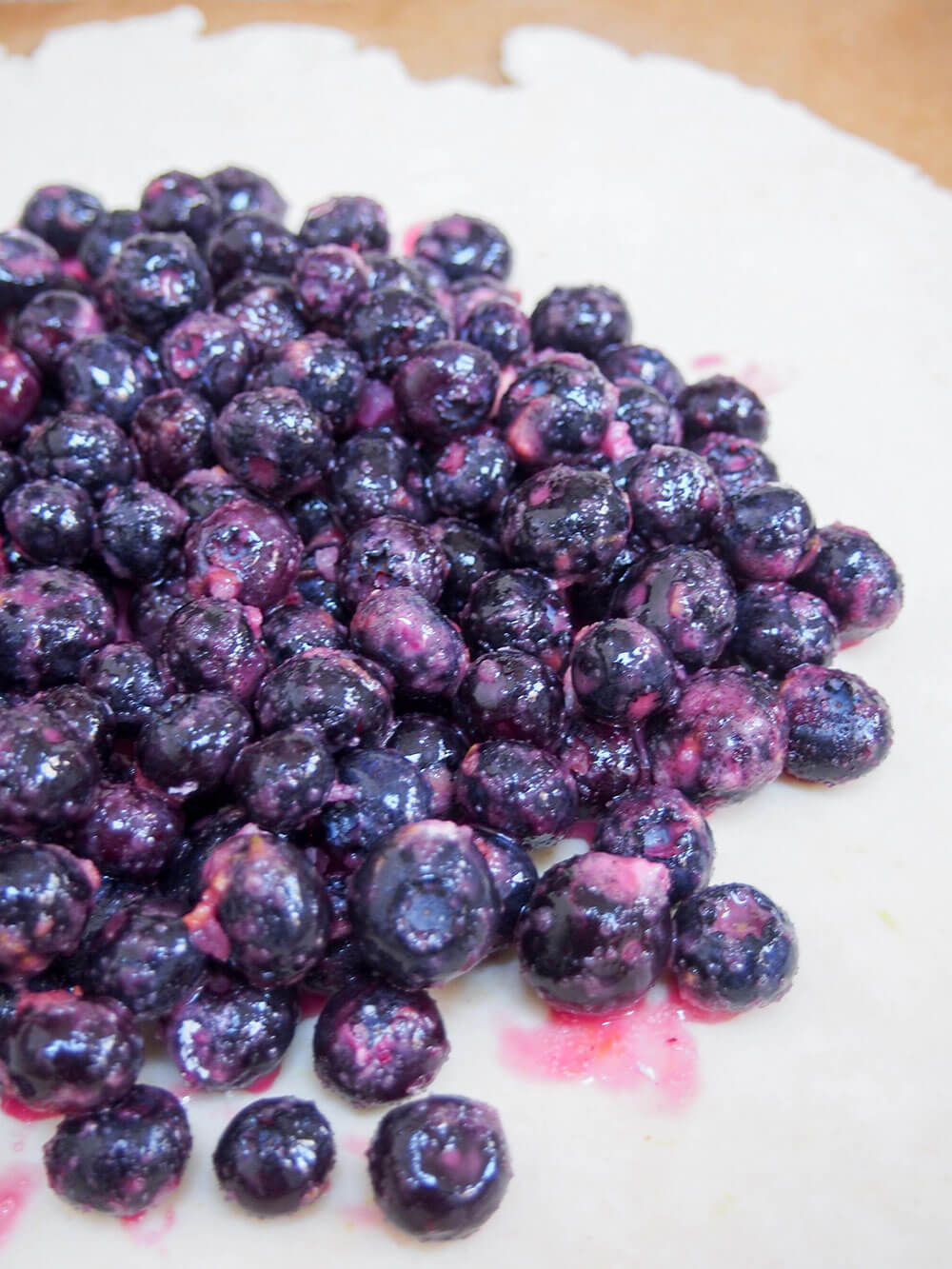 putting blueberries on top of pastry