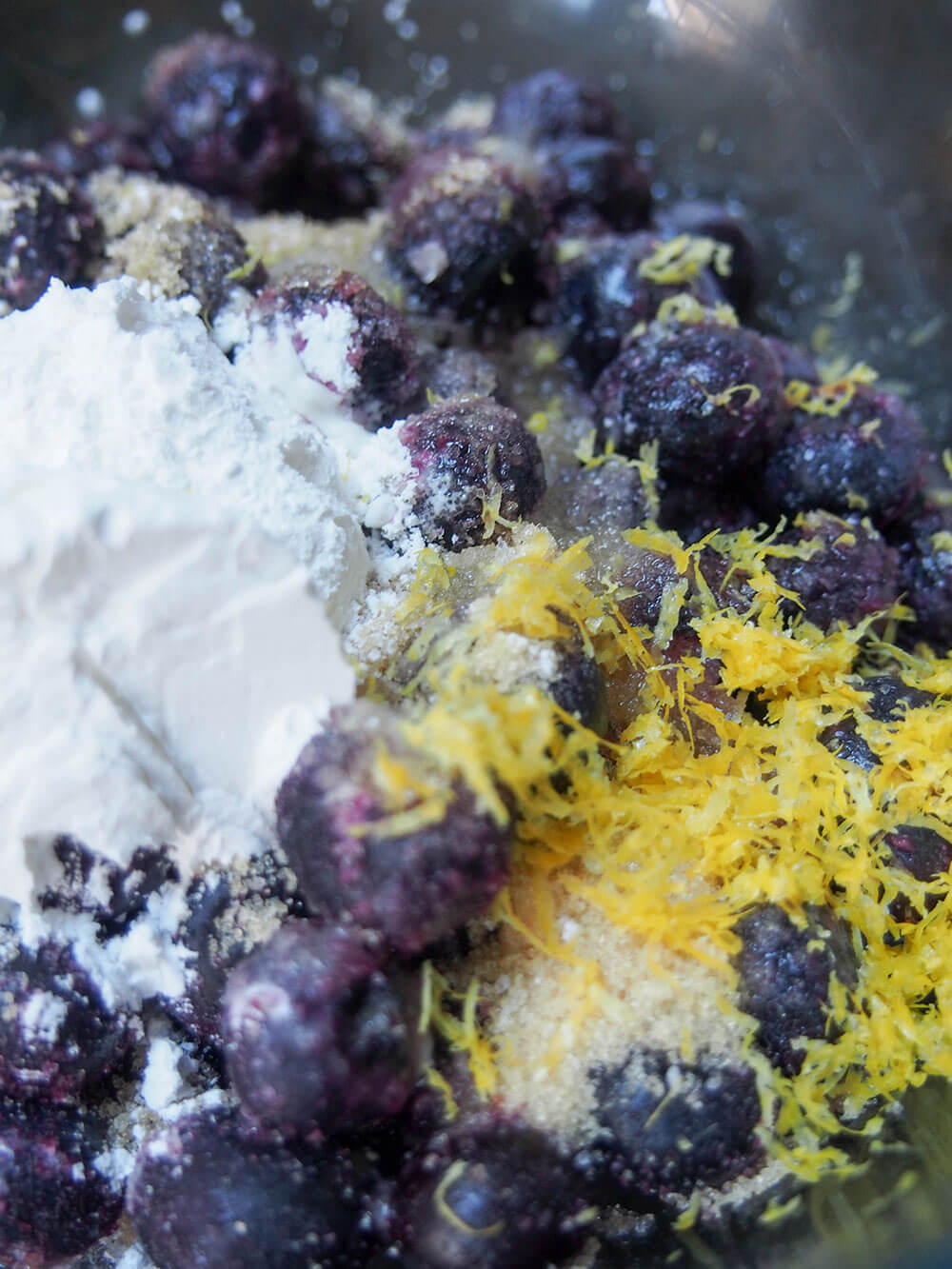 mixing berries with lemon zest and corn starch