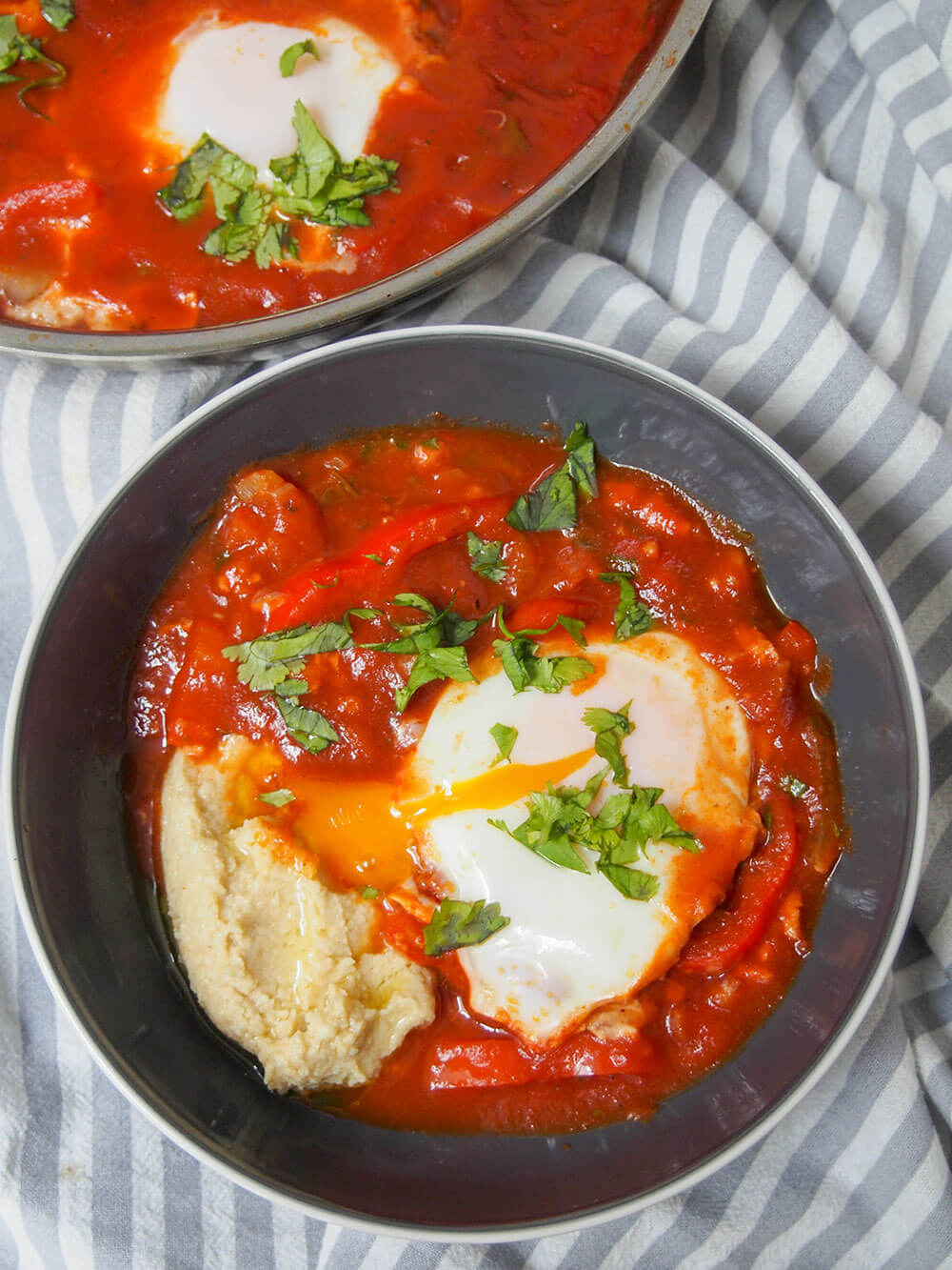 shakshuka hummus with egg yolk bleeding into sauce