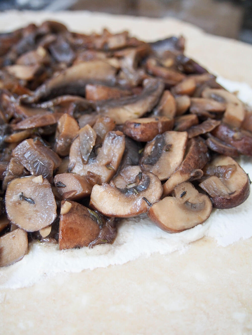adding mushroom layer on top of ricotta on pastry