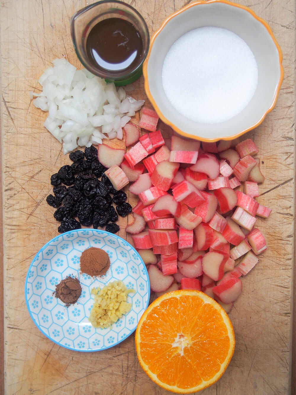 rhubarb chutney ingredients in dishes or directly on chopping board, in groups