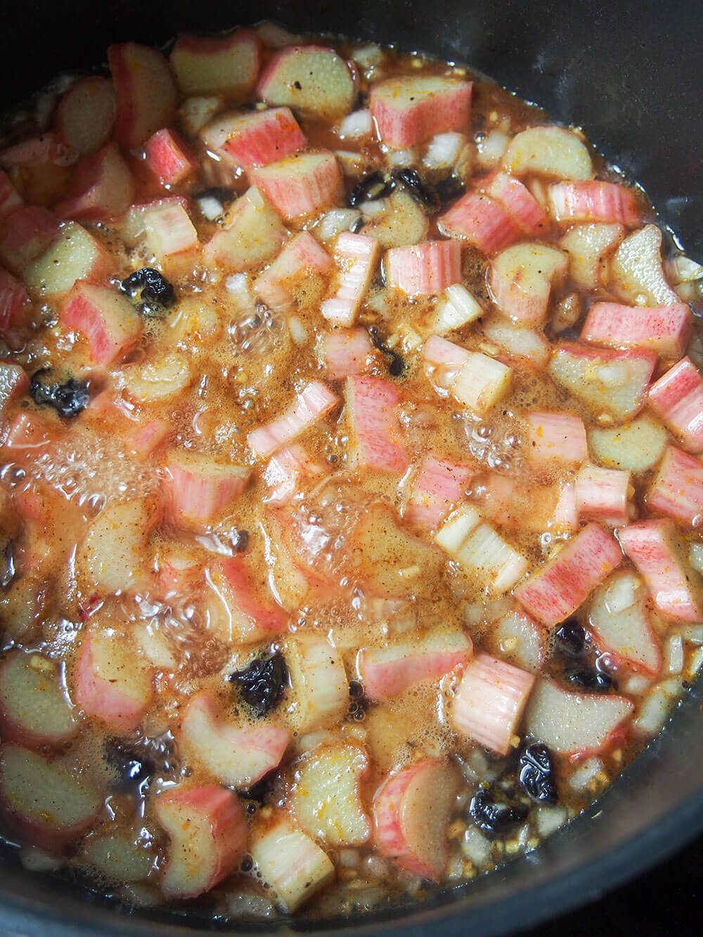 simmering rhubarb chutney - rhubarb pieces still in chunks