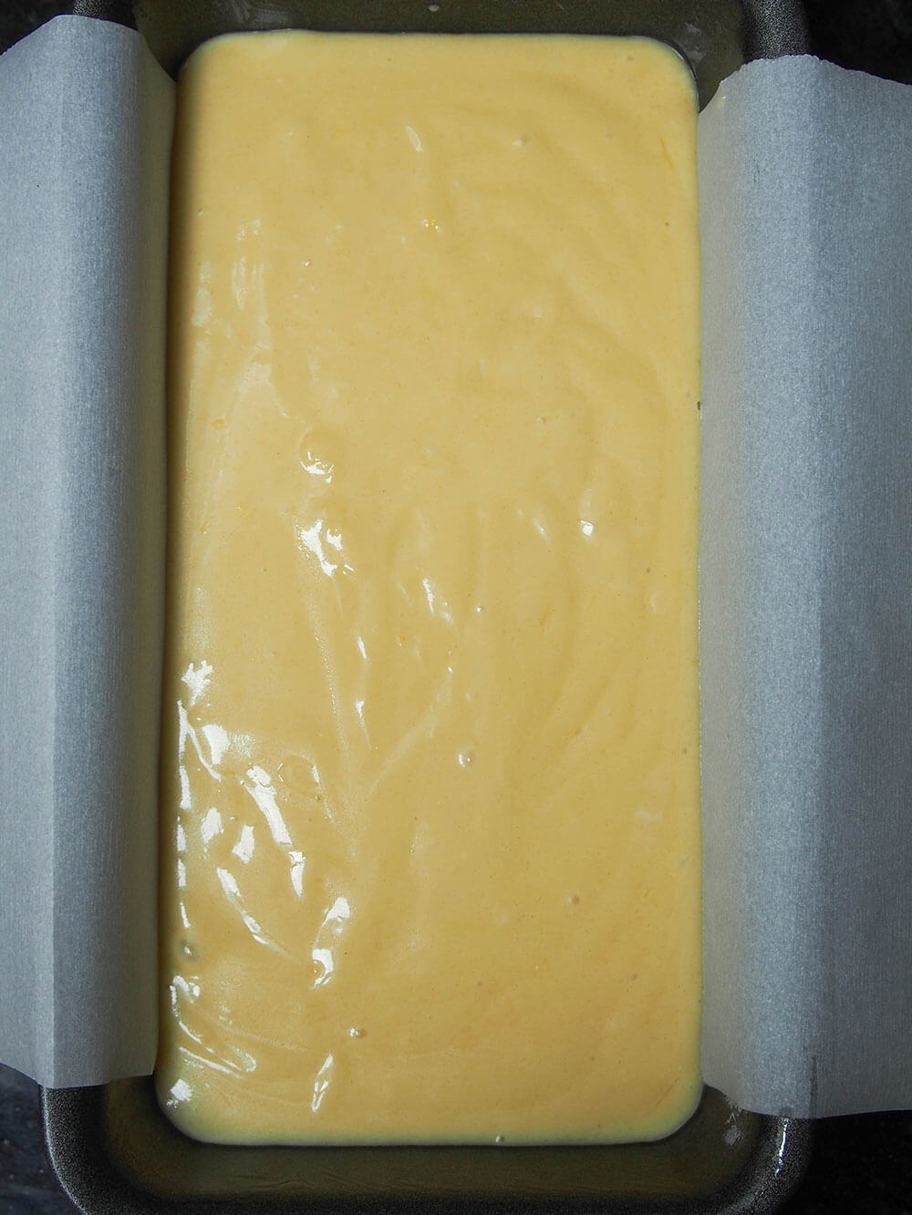French lemon yogurt cake batter in loaf pan ready to bake