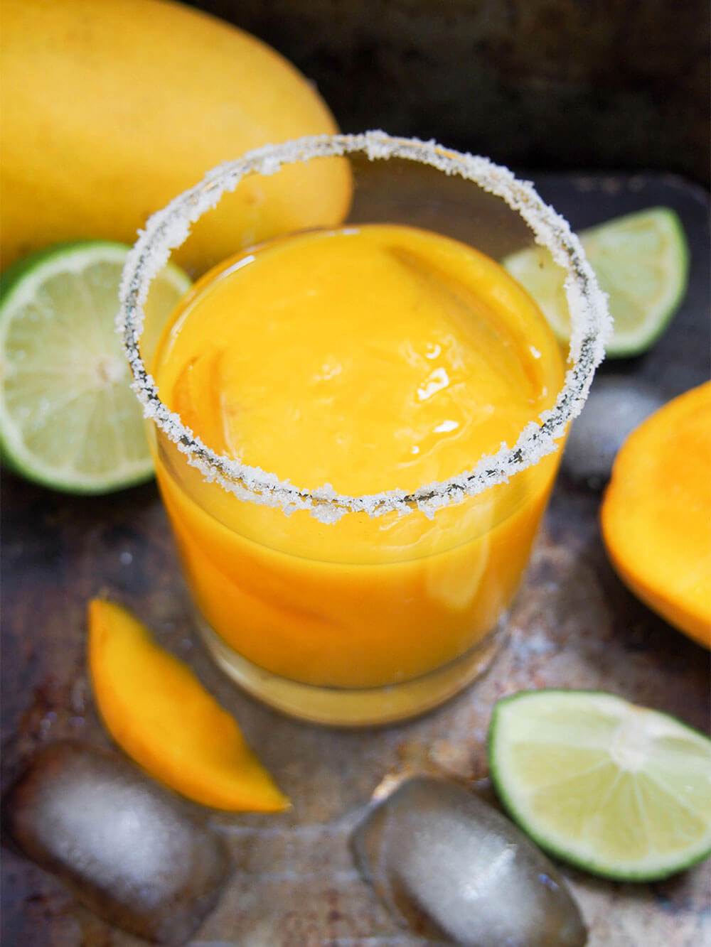 glass of mango margarita with salt rimmed glass