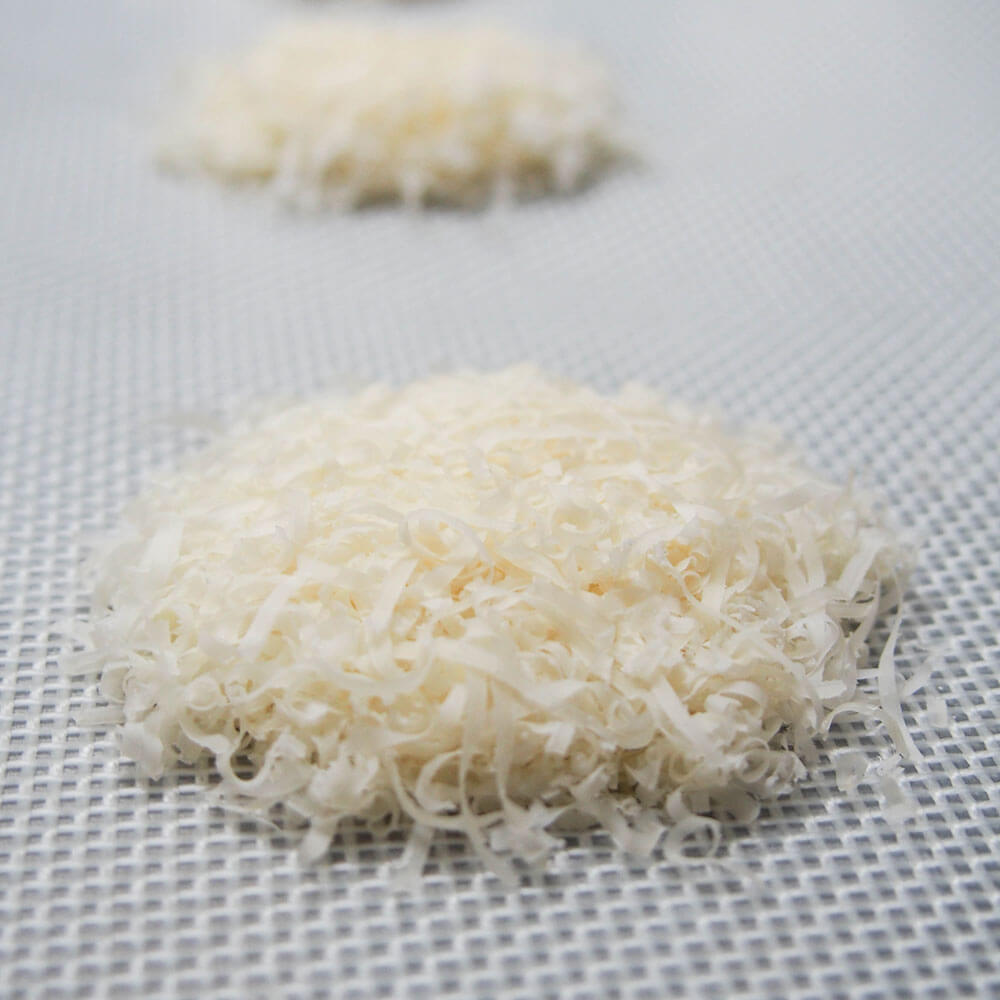 small stacks of grated parmesan on baking sheet to make parmesan crisps