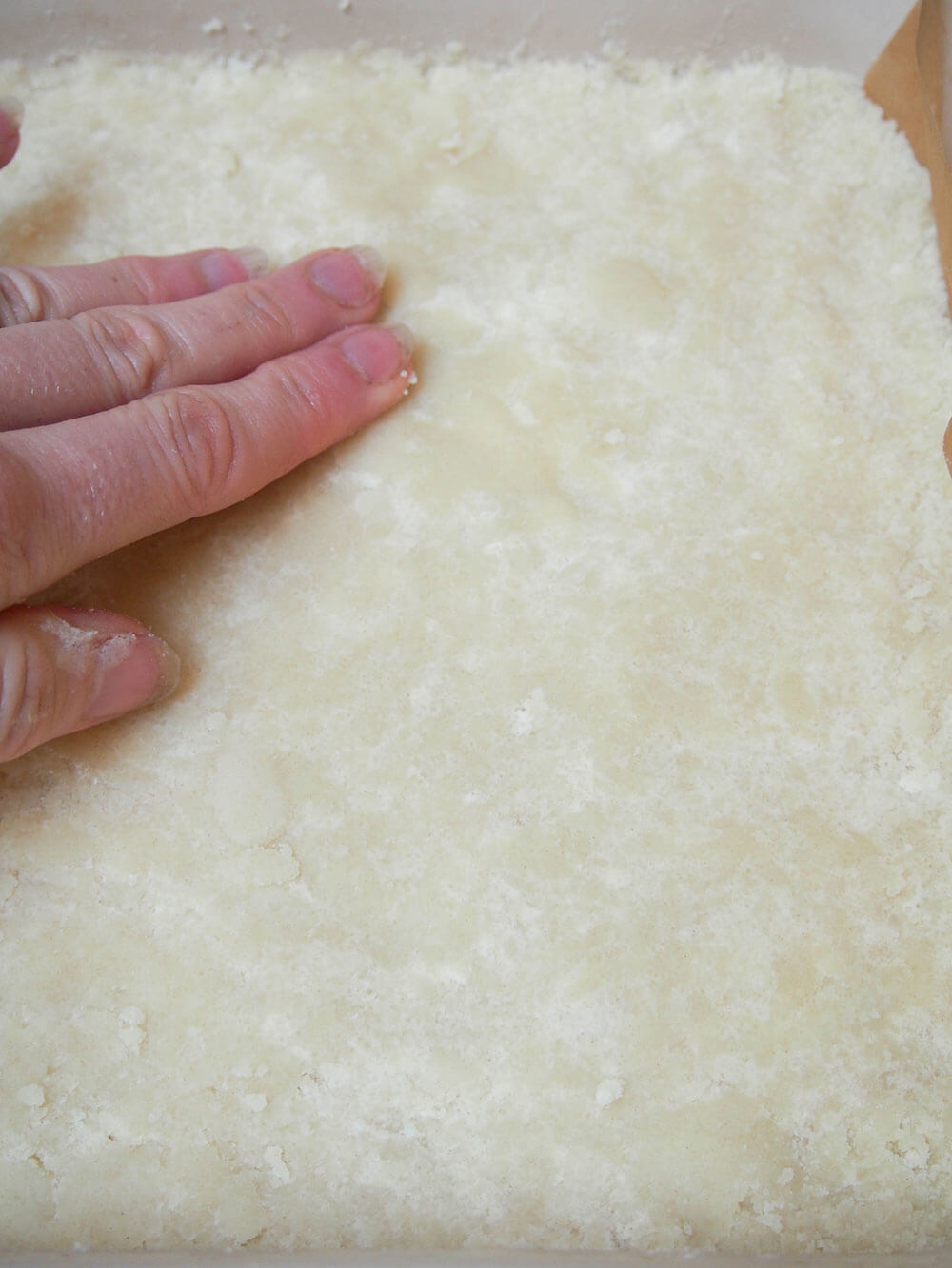 pressing shortbread into dish before baking