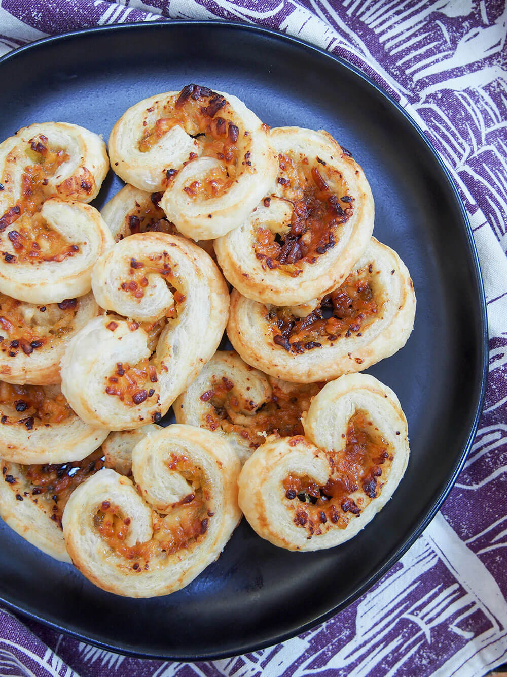 cheese and fig savory palmiers on plate from overhead