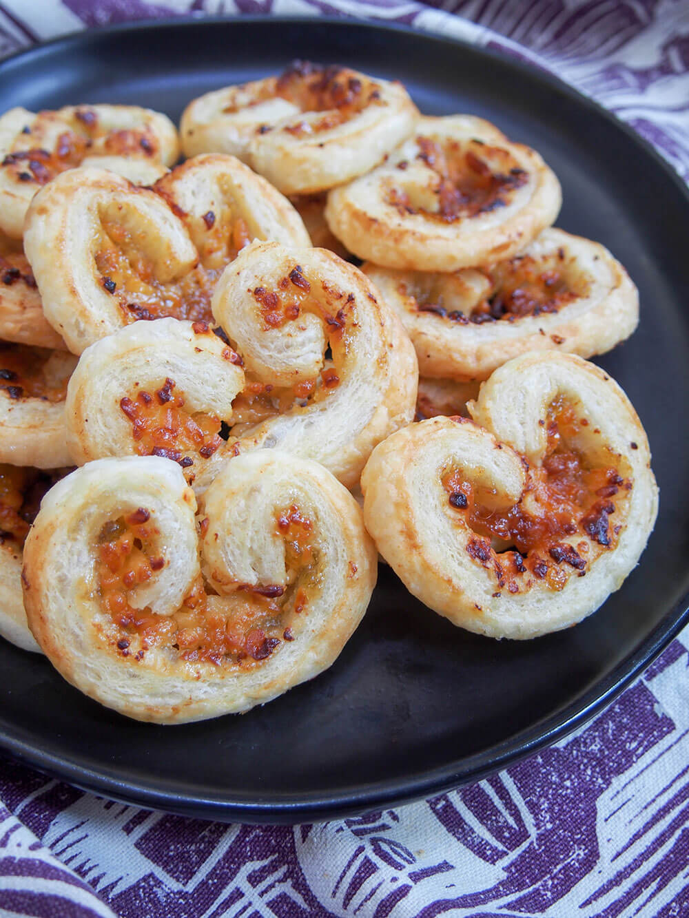 cheese and fig savory palmiers stacked on plate