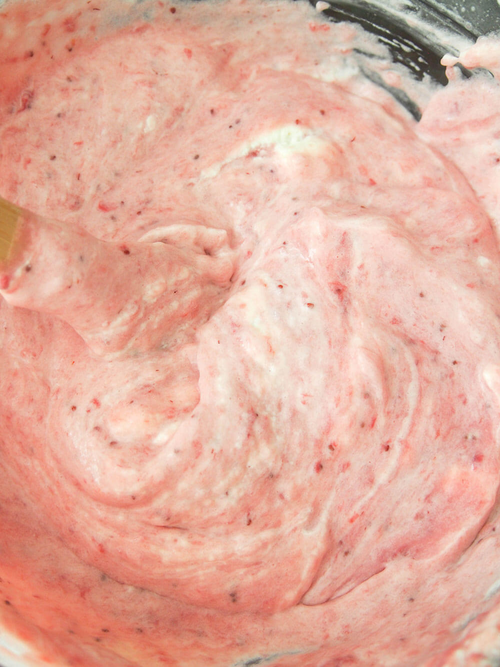 folding cream and strawberry mixtures together