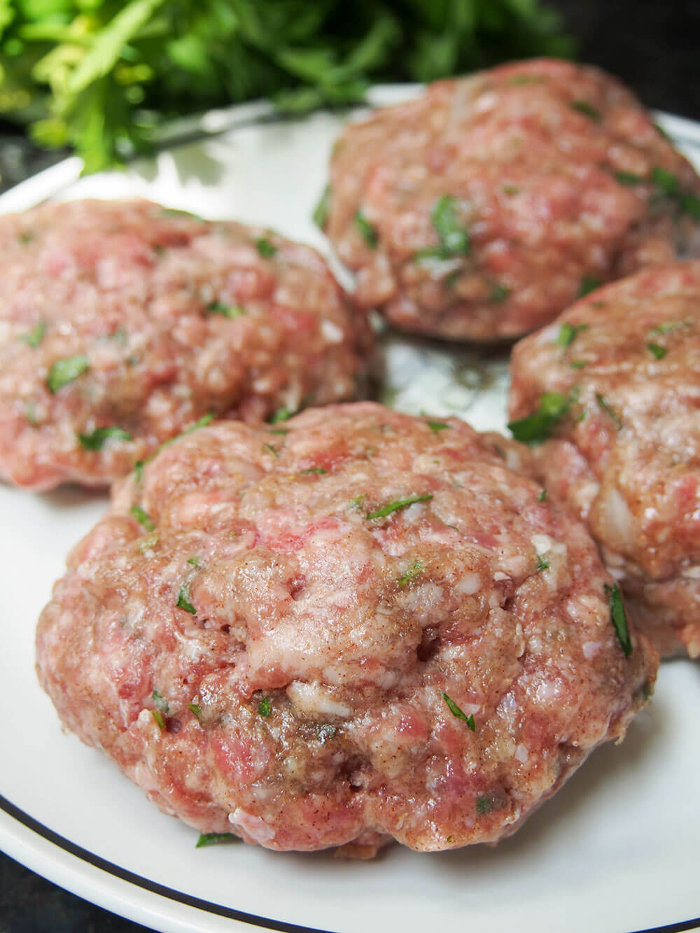 formed lamb kofte burgers on plate ready to cook