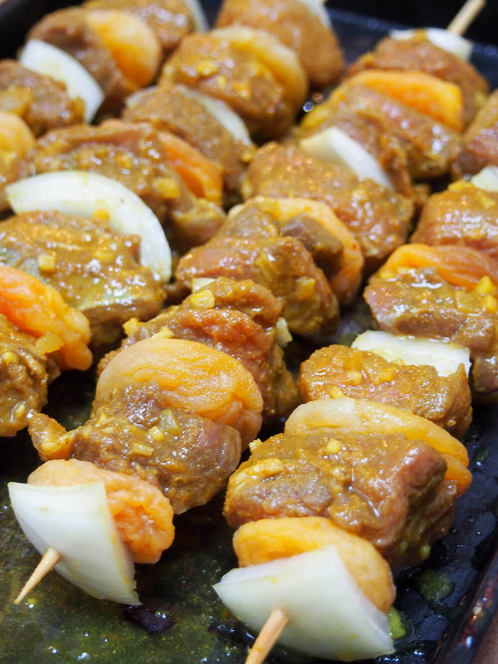 Sosaties (South African lamb and apricot kebabs) on skewers ready to cook