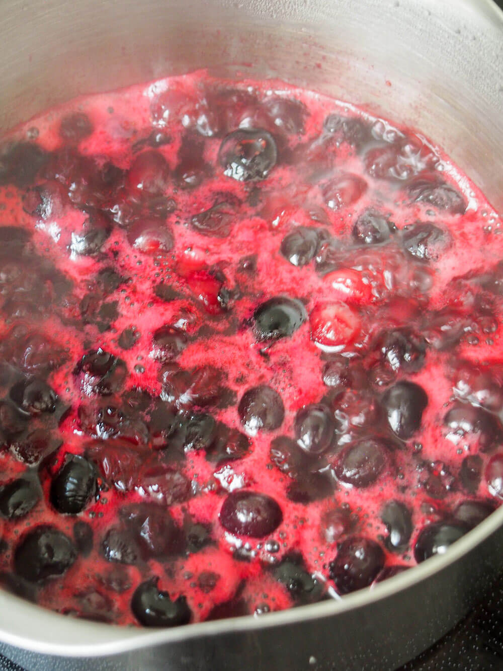simmering blueberries for blueberry curd