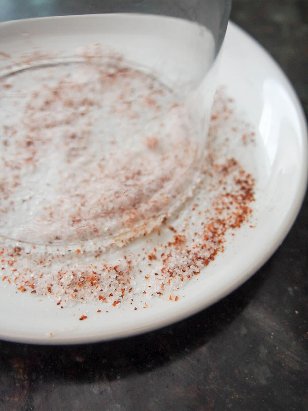 adding chili salt rim to top of glass