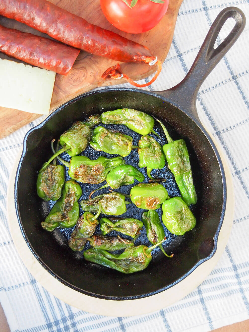 Padron peppers with cheese, chorizo and tomato on side