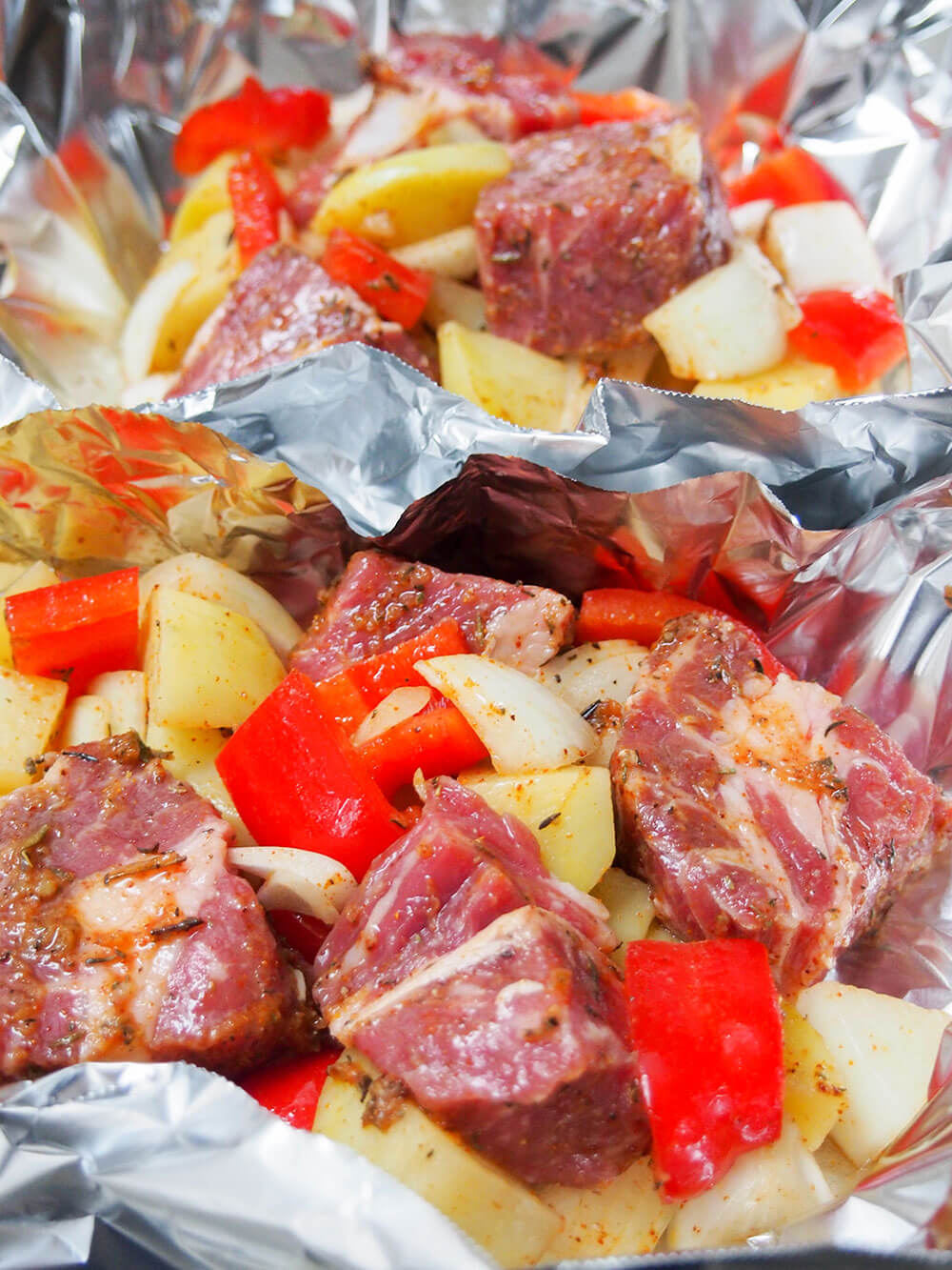 Two steak foil packets before cooking