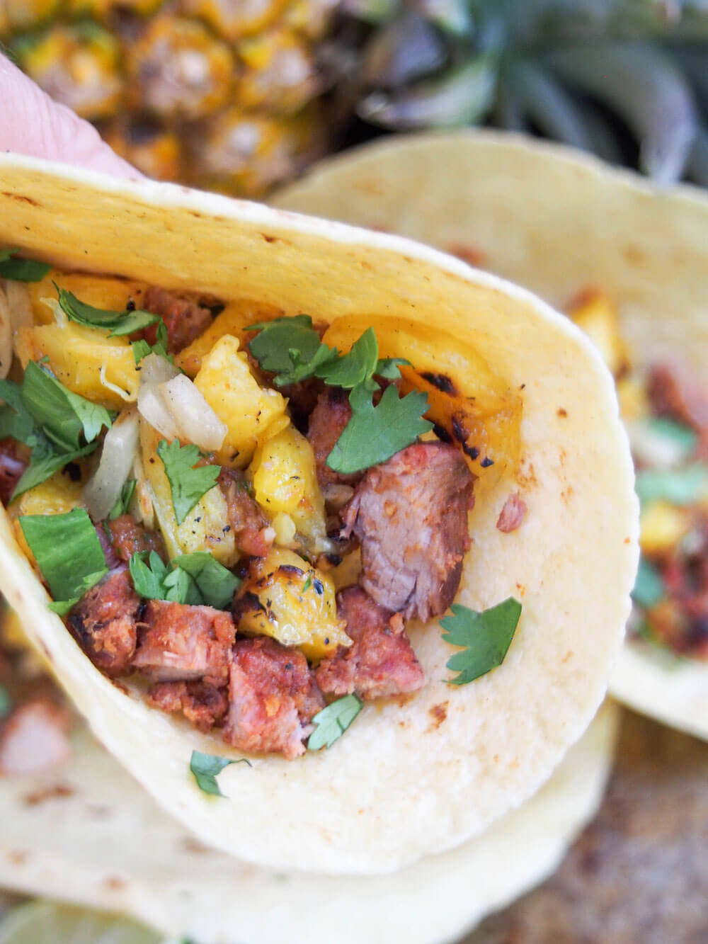 tacos held in hand showing filling